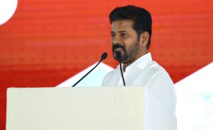 Chief Minister A. Revanth Reddy addressing a crowd, emphasizing the need for unity among Telugus in politics.