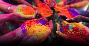 Holi celebration with people throwing colorful powders.