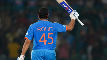 Rohit Sharma celebrating after hitting a six in a cricket match.